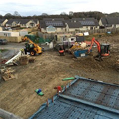 Building site with mini digger, Cardigan